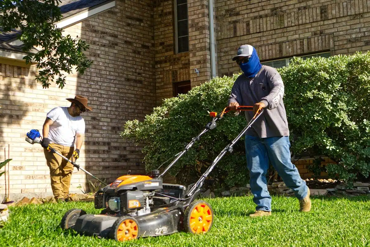 Lawn crew mowing and trimming