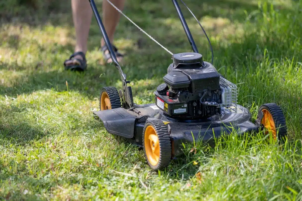 Homeowner mowing a green lawn