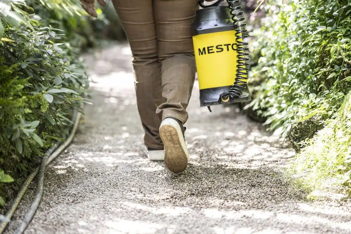 Pest-control technician treating a home exterior